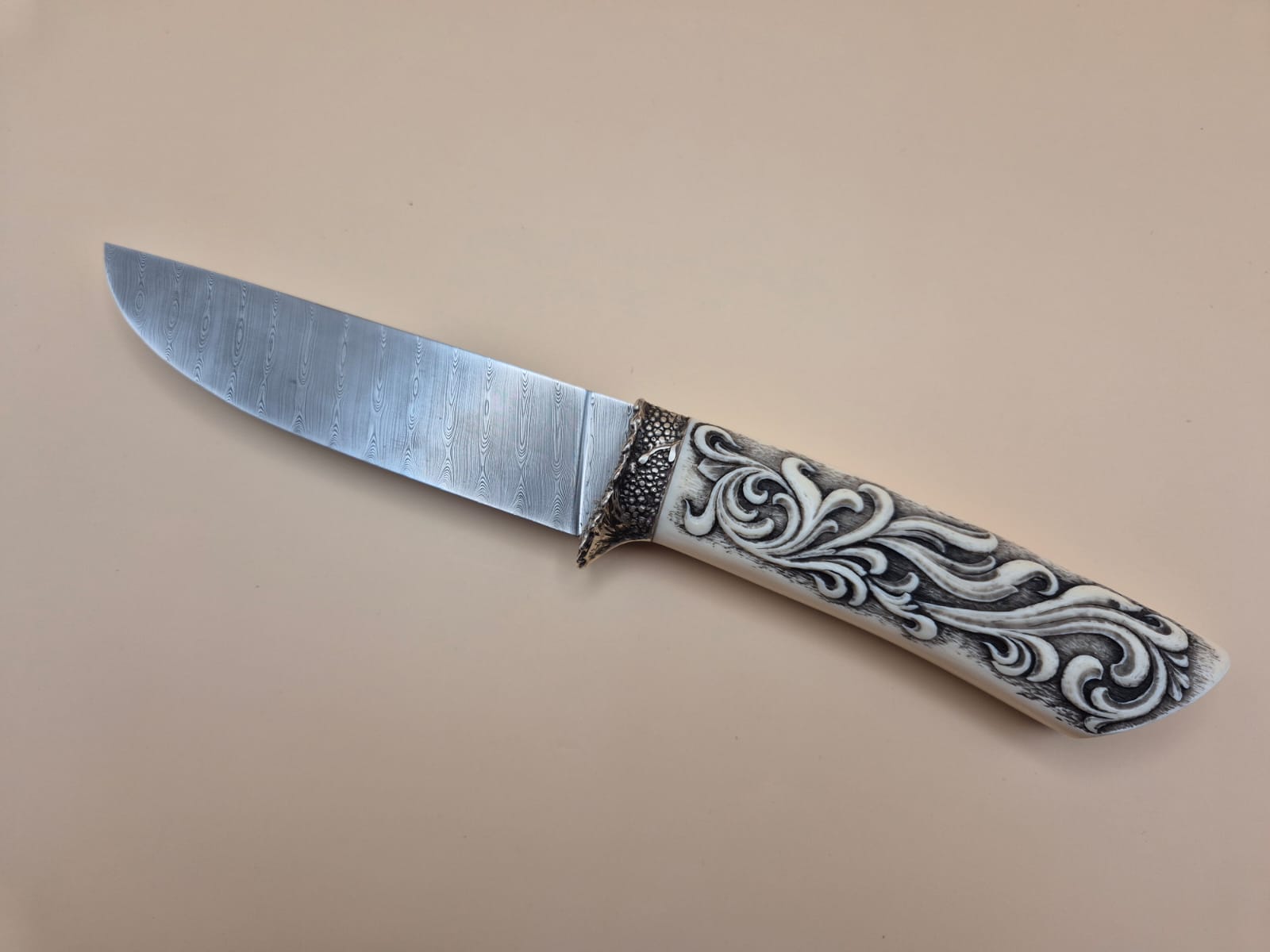 Hand-forged Damascus knife with carved antler handle