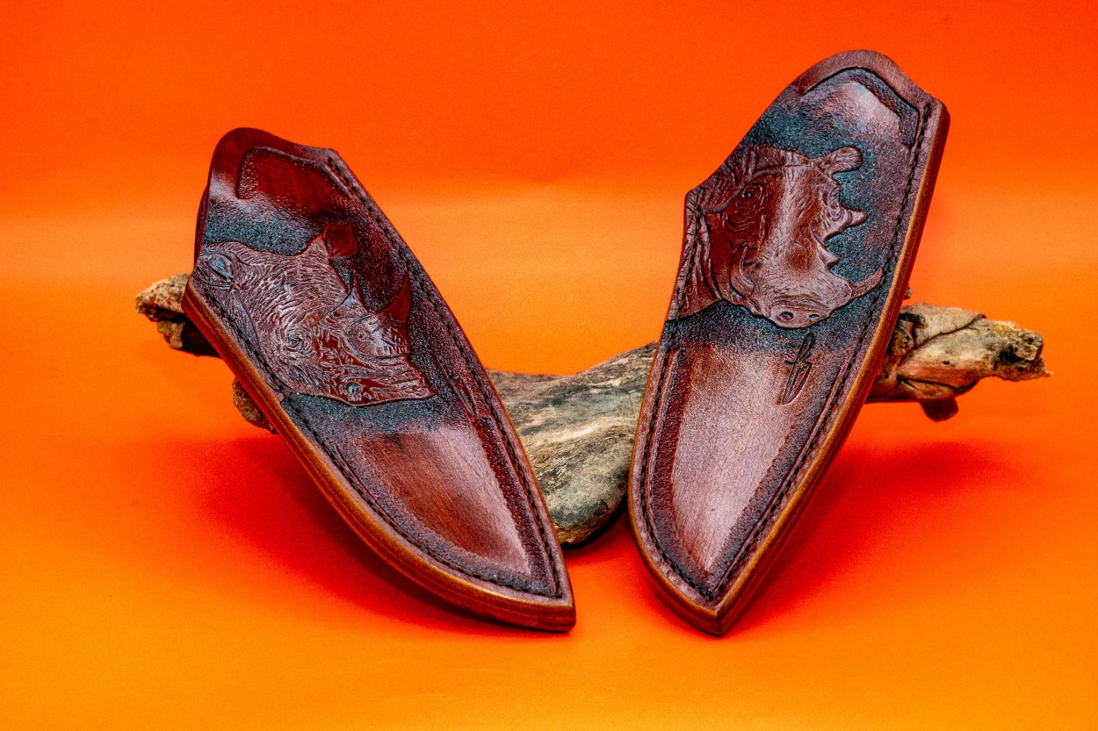 Hand-stitched leather hunting knife sheath with tooled details